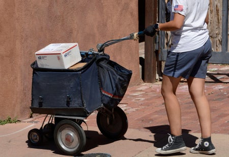 Closeup shot of a postal worker delivering mail and packages